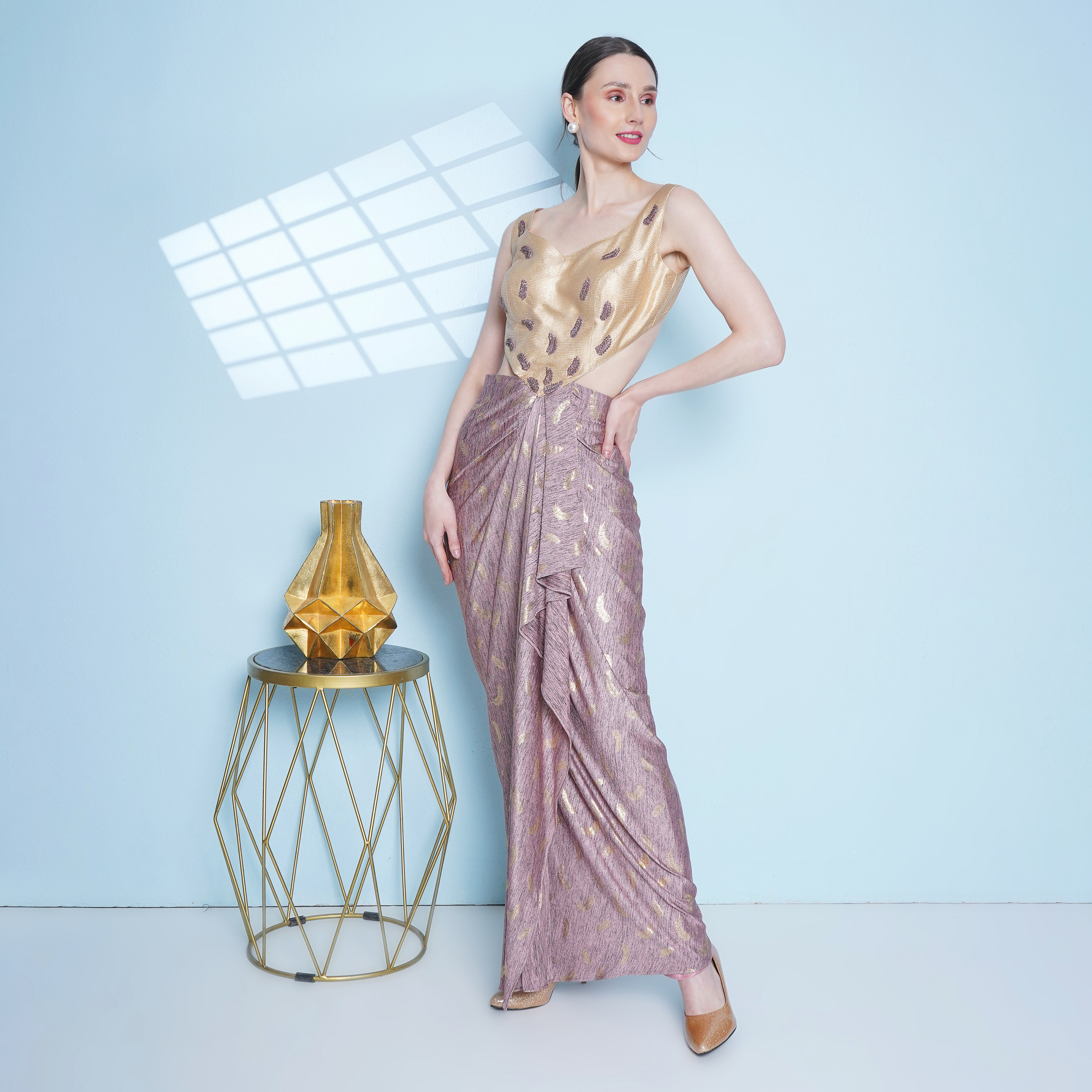 Mauve and gold drape gown embellished with delicate motif embroidery. Can be worn with a tiered cape
